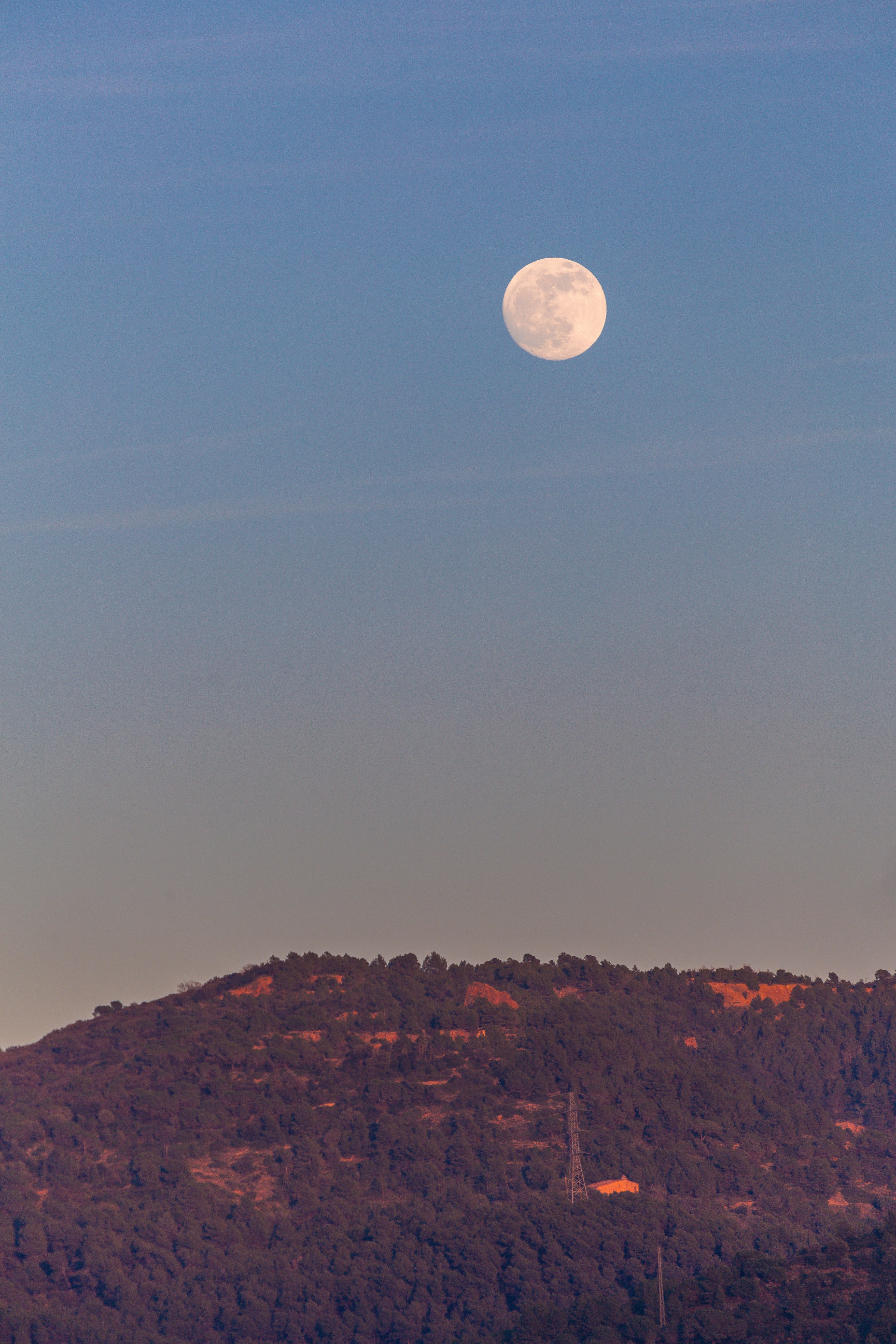 full moon over brown mountain